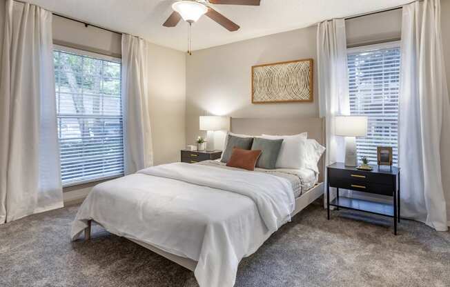 a bedroom with a bed and a ceiling fan at Roswell Village, Roswell
