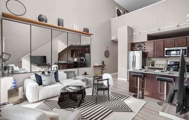 A modern living room with a white couch and a black and white rug.