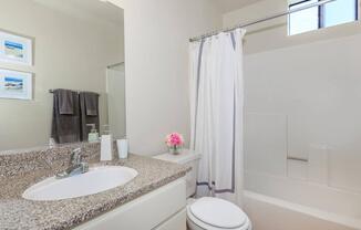 a large white tub next to a sink