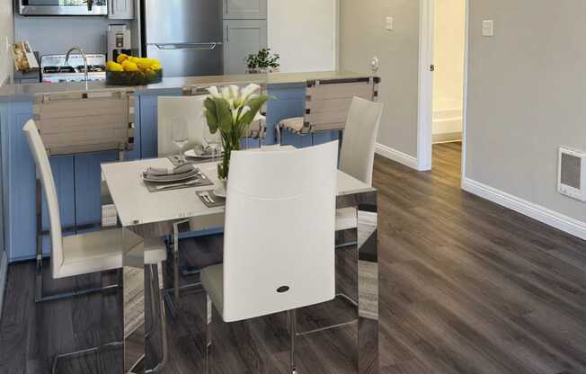 a kitchen and dining room with a table and chairs