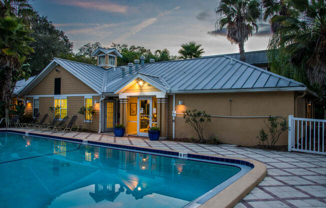 a house with a pool in front of it