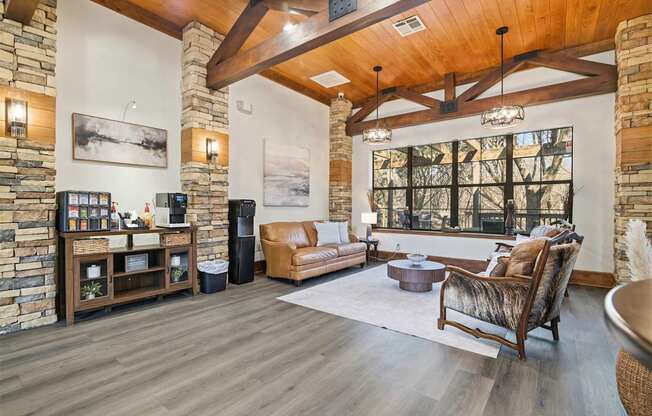 A living room with a stone wall and wood flooring.