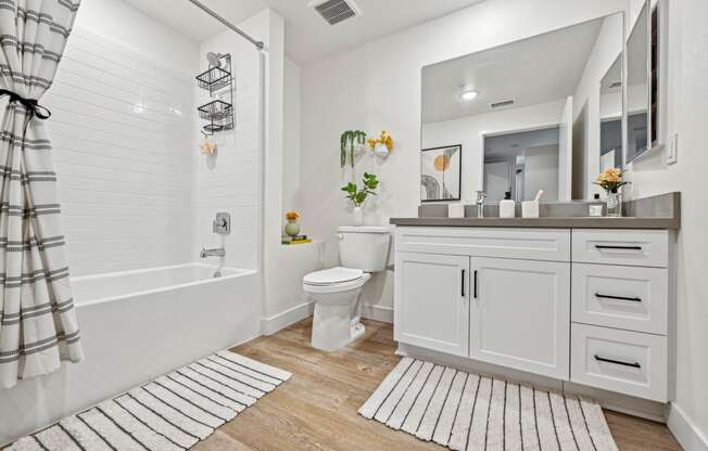 a white bathroom with a shower and a toilet