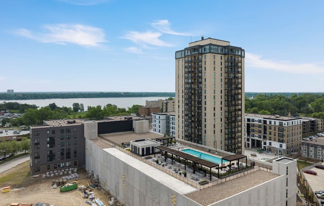 a view of a tall building with a pool in front of it