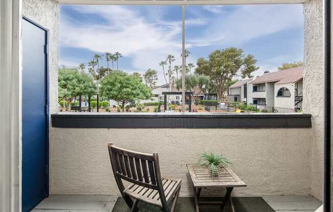 A picture of a patio with a chair and table