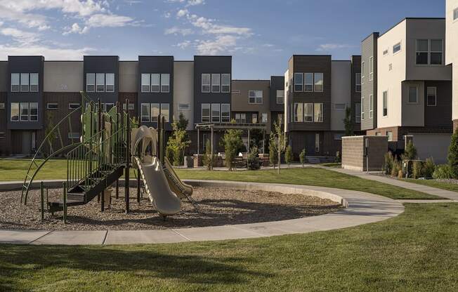 Playground with Surrounding Grass at Parc View Apartments and Townhomes Midvale, UT 84047