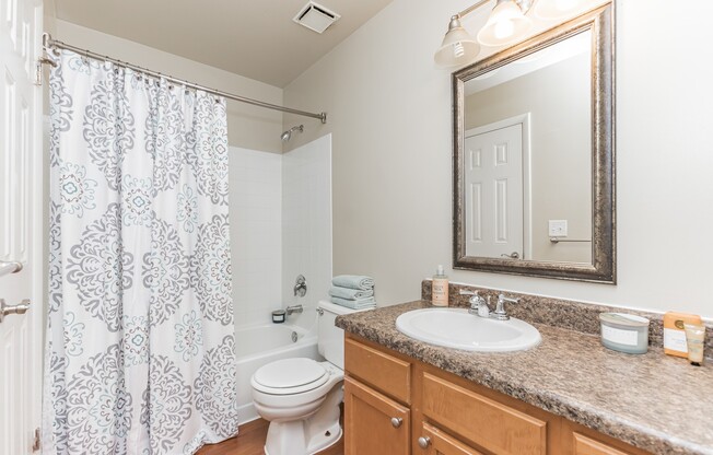 Stylish bathroom with modern finishes and ample storage at Eagle Rock Apartments at Columbia. Enjoy a space designed for comfort and convenience, perfect for your daily routine. Explore your new home today!