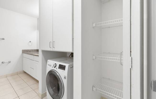 a white laundry room with a washer and dryer in it