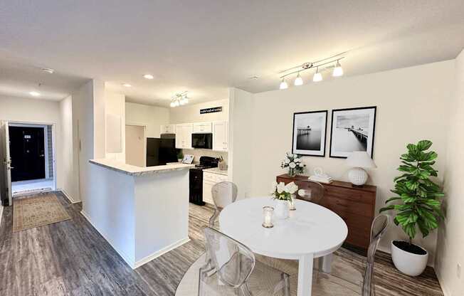 A modern kitchen with a dining table and chairs.