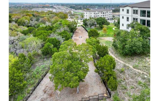 an aerial view of a park with trees and buildings