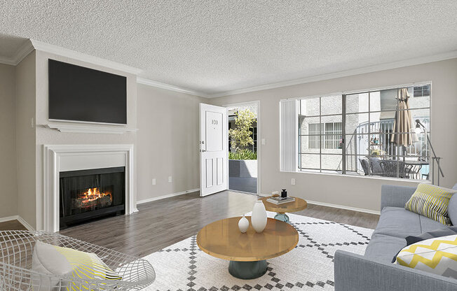 Living room with hardwood floor and large windows for natural light.