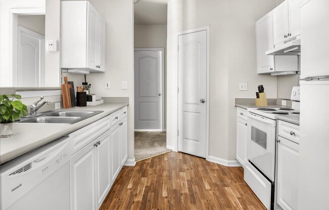 a kitchen with white cabinets and white appliances