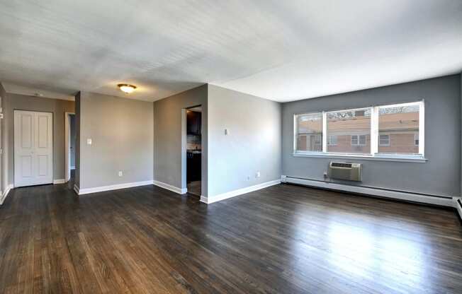 a living room with hardwood floors and grey walls