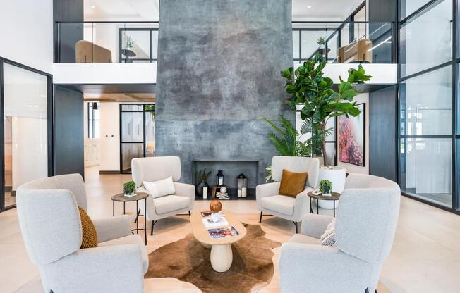 Stylish and inviting lounge space with high ceilings, modern seating, and a fireplace feature—perfect for casual conversation or quiet moments.