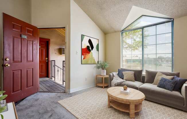 an open living room and kitchen with a couch and table