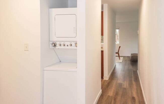 A long hallway with a washer and dryer to the left at our apartments for rent in Renton, WA
