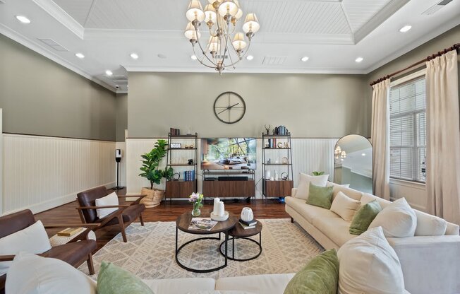 a living room with gray walls and a chandelier