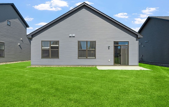 a renovated house with a yard in front of it