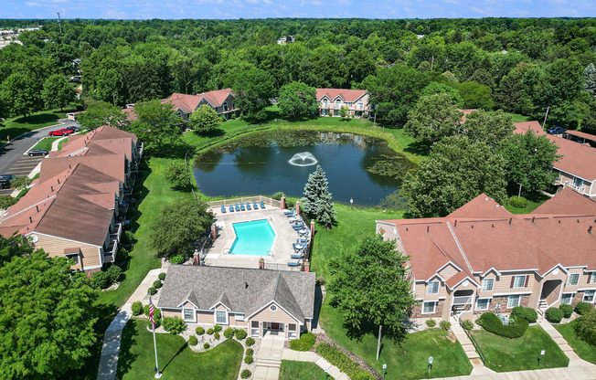 an aerial view of Hampton Lakes neighborhood with a swimming pool and a pond, Walker, MI