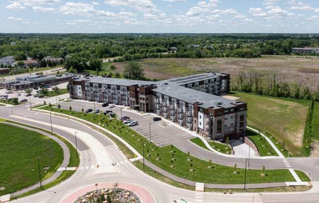 an aerial view of an apartment building next to a road