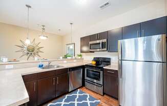 full kitchen with stainless steel appliances at the reserve at walnut creek apartments