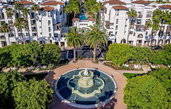 aerial view of promenade rio vista apartments and water fountain with lush landscaping
