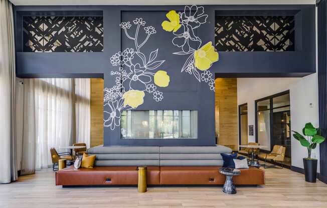 a living room with a blue wall and a couch and a large window