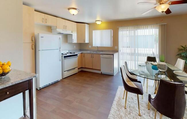 a kitchen and dining room with a table and chairs