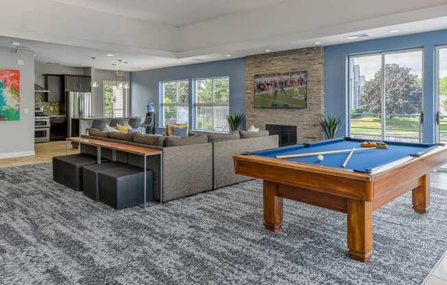 a clubhouse with a pool table and couches