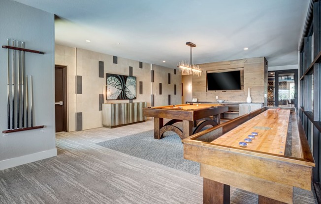 a games room with a shuffleboard and foosball table