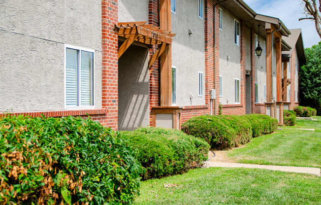 A building with a red brick archway and a white window.
