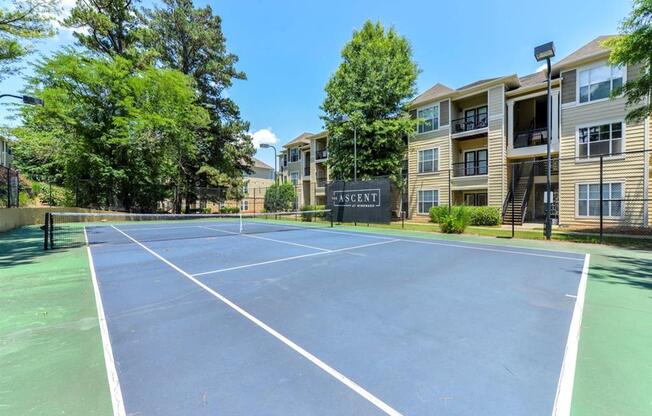 Newly Renovated Apartments in Alpharetta GA - The Ascent at Windward Outdoor Tennis Court and Exterior View of the Apartment Buildings