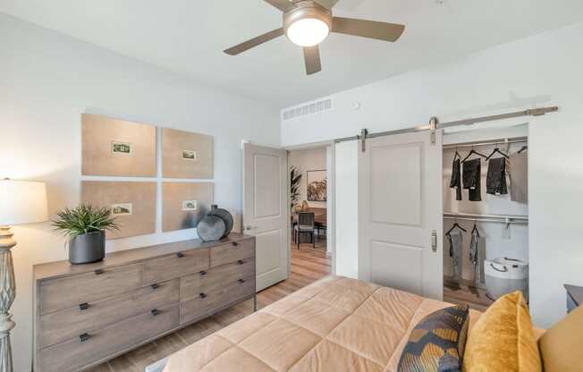 a bedroom with a ceiling fan and a closetat Weylyn Luxury Apartments, Laveen, AZ