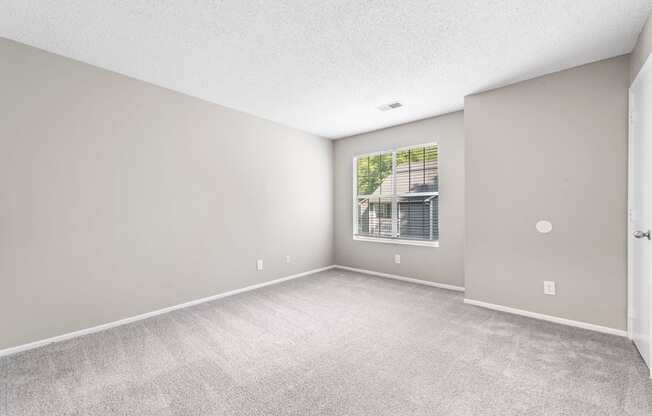 an empty living room with a large window