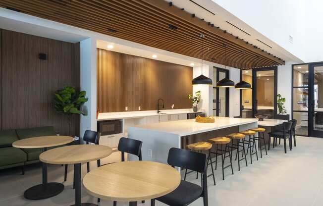 a kitchen and dining area with wooden tables and chairs