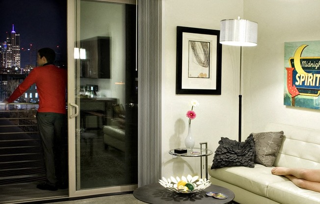 a man standing in a living room next to a glass door