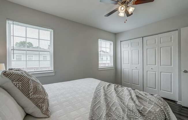 a bedroom with a large bed and a ceiling fan