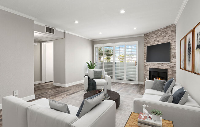 Hardwood floored living room with stone accented fireplace.