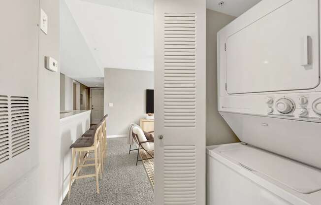 a room with a refrigerator and a table with chairs