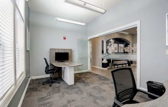 a conference room with a fireplace and a desk and chairs