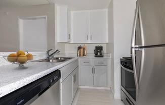 a kitchen with a sink and a refrigerator