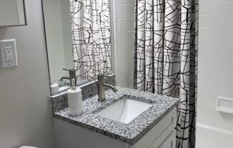 a bathroom with a sink and a shower curtain