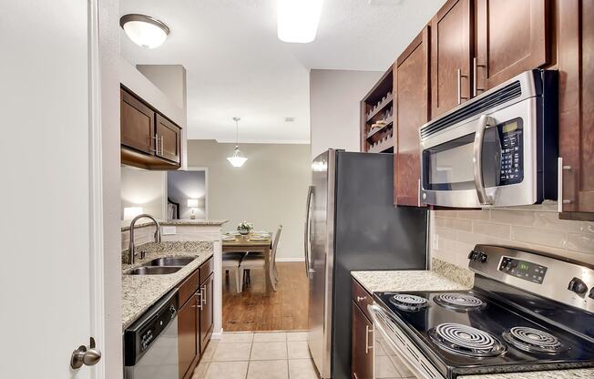 a kitchen with stainless steel appliances and wood cabinets