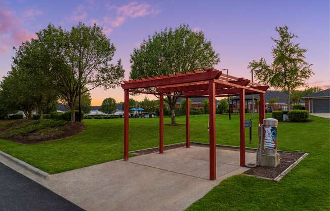 a park with a pavilion and a trash can