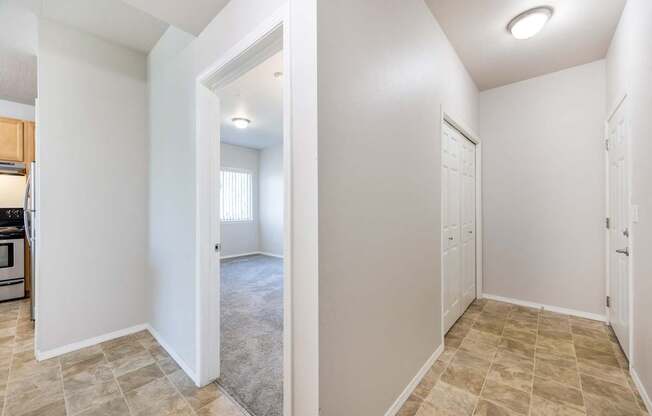 A white room with a doorway leading to another room.