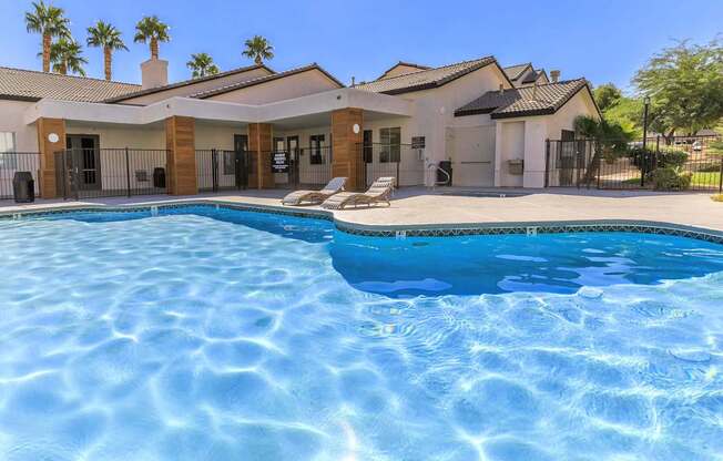 A swimming pool in front of a house.