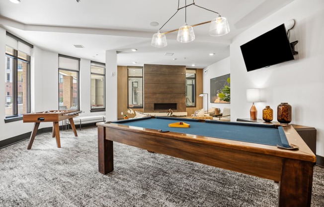 a games room with a pool table and a television