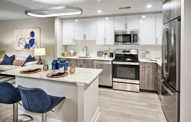 Expansive Kitchens With Quartz Countertops, Two-Tone Cabinetry, Energy Efficient Stainless Steel Appliances, Islands and Wood-Style Flooring