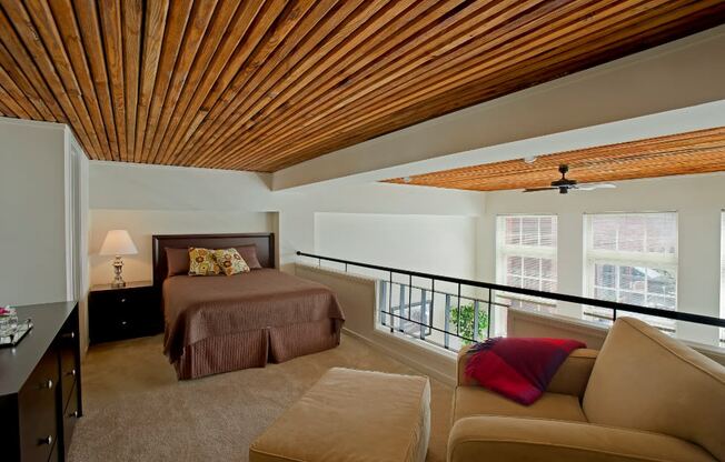 a bedroom with a bed and a couch and a balcony at Tindeco Wharf, Maryland