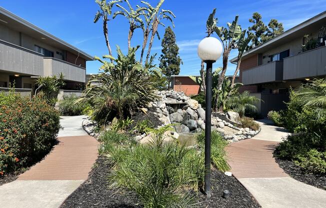 a courtyard with plants and a lamp post